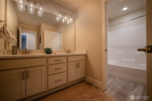 29027 NE 156th St, Duvall, WA 98019 - bathroom featuring double vanity, baseboards, a sink, and wood finished floors