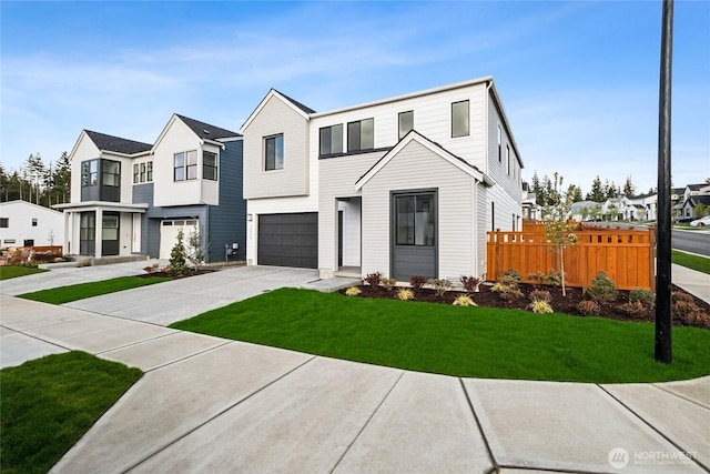 multi unit property with a garage, fence, a front lawn, driveway, and a residential view