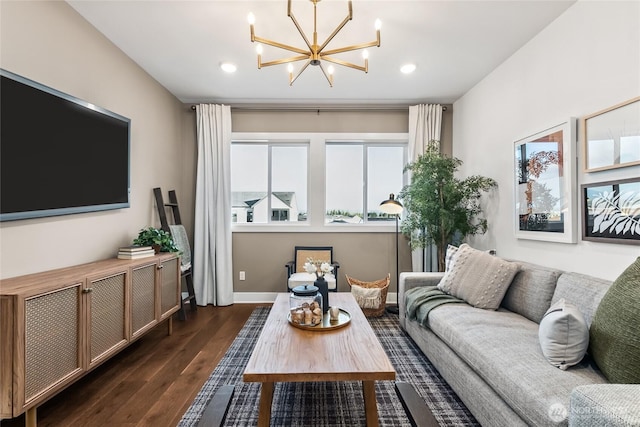 living area with recessed lighting, baseboards, an inviting chandelier, and dark wood finished floors