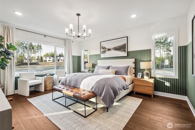 bedroom featuring recessed lighting, multiple windows, a notable chandelier, and hardwood / wood-style flooring