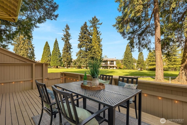 wooden deck with a yard, view of golf course, and outdoor dining area