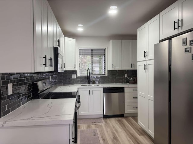 11703 NE 80th St Unit D3, Kirkland, WA 98033 - kitchen with a sink, stainless steel appliances, tasteful backsplash, and light stone countertops
