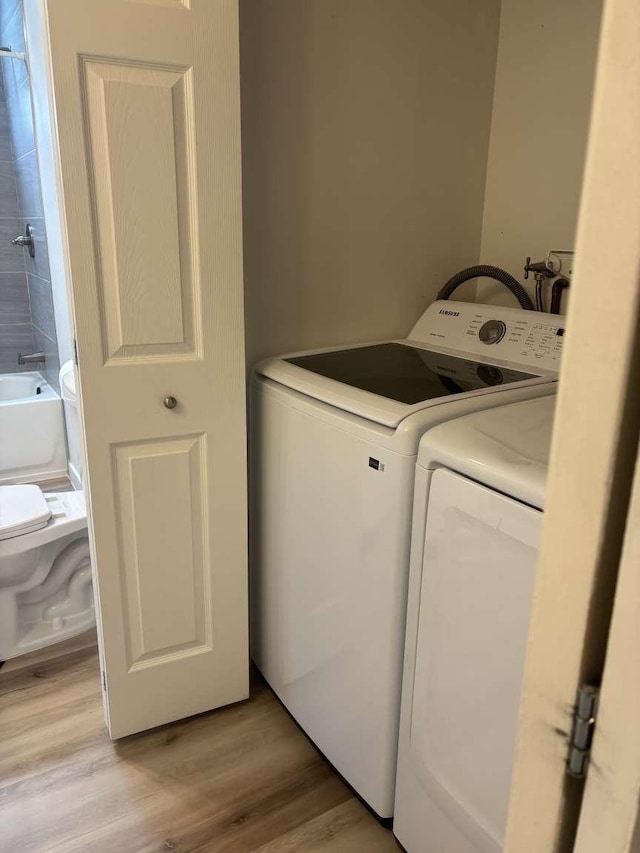 11703 NE 80th St Unit D3, Kirkland, WA 98033 - laundry room featuring independent washer and dryer, light wood-type flooring, and laundry area