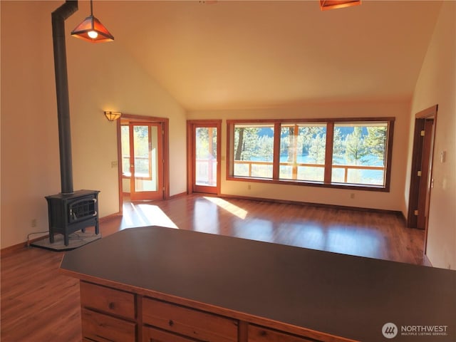living area featuring lofted ceiling, wood finished floors, and plenty of natural light
