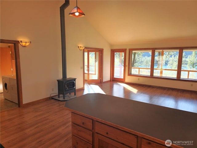 living room with wood finished floors, plenty of natural light, and washer and clothes dryer