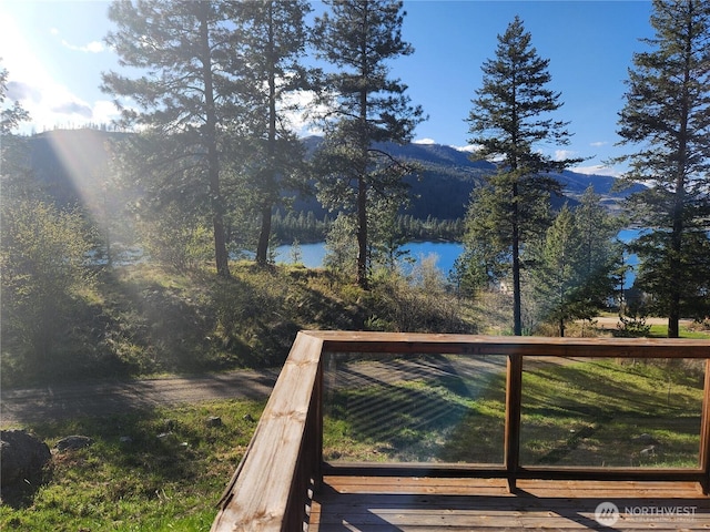 wooden terrace with a water and mountain view