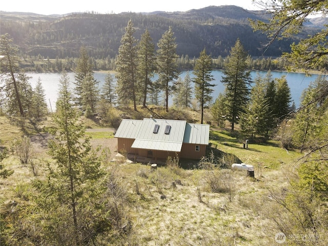 aerial view with a forest view and a water and mountain view