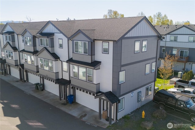 view of front of property with an attached garage and a shingled roof