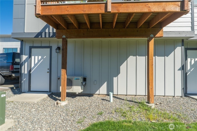 entrance to property with board and batten siding and ac unit