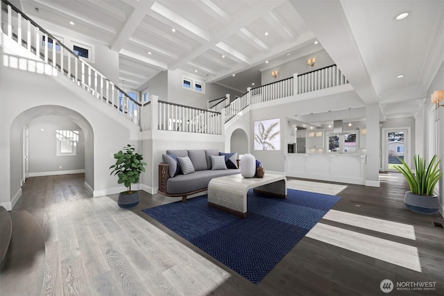 581 Marine Dr, Point Roberts, WA 98281 - living room with baseboards, a towering ceiling, arched walkways, and a healthy amount of sunlight