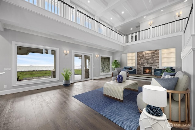 581 Marine Dr, Point Roberts, WA 98281 - living room featuring a towering ceiling, wood finished floors, beam ceiling, baseboards, and a fireplace