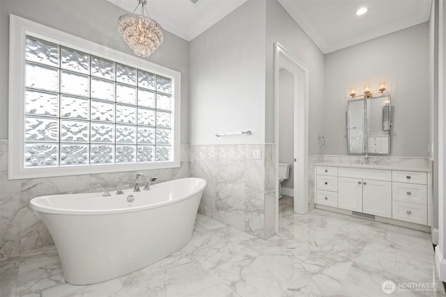 581 Marine Dr, Point Roberts, WA 98281 - bathroom with a soaking tub, marble finish floor, an inviting chandelier, and crown molding