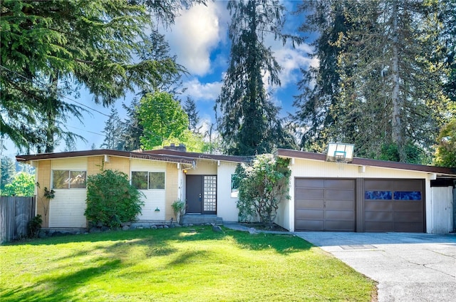 ranch-style house featuring a garage, a front lawn, fence, and concrete driveway
