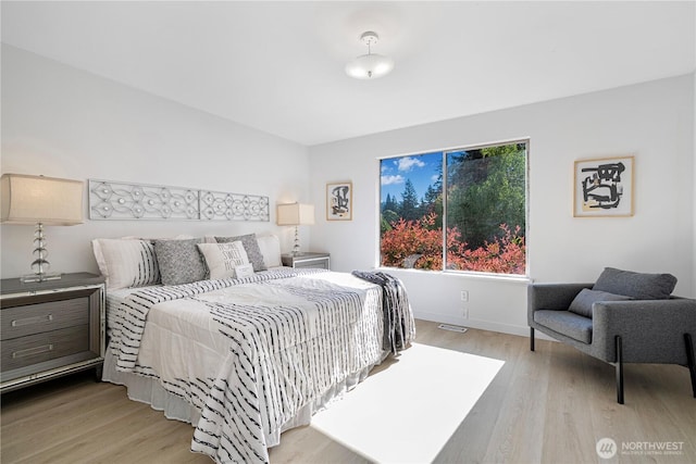 bedroom featuring baseboards and wood finished floors