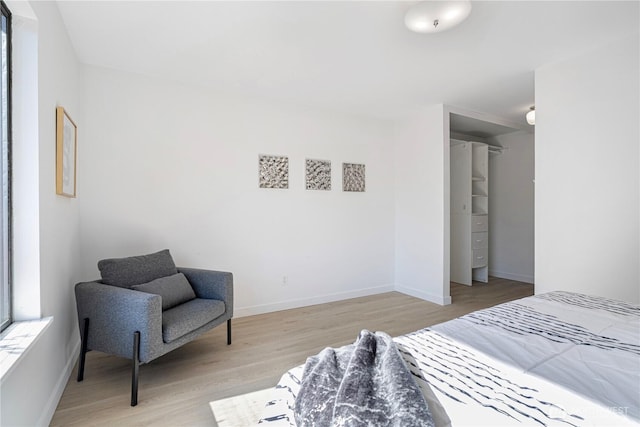 bedroom with baseboards and light wood-type flooring