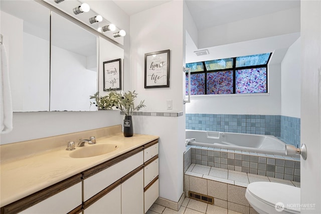 full bath featuring vanity, toilet, tile patterned floors, visible vents, and a garden tub