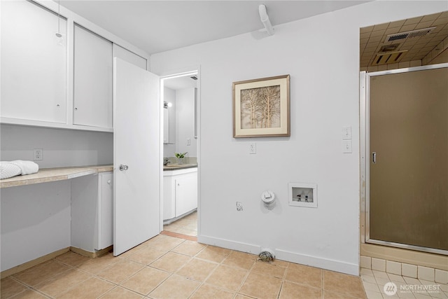clothes washing area with cabinet space, visible vents, light tile patterned floors, and hookup for a washing machine