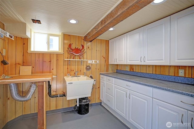 laundry area featuring wooden walls, a sink, and recessed lighting