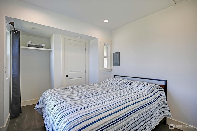 bedroom featuring recessed lighting, electric panel, baseboards, and dark wood-style flooring