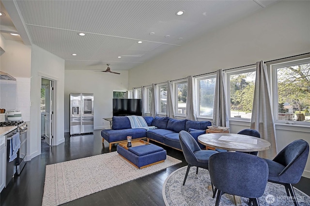 living room with dark wood finished floors, a ceiling fan, and recessed lighting