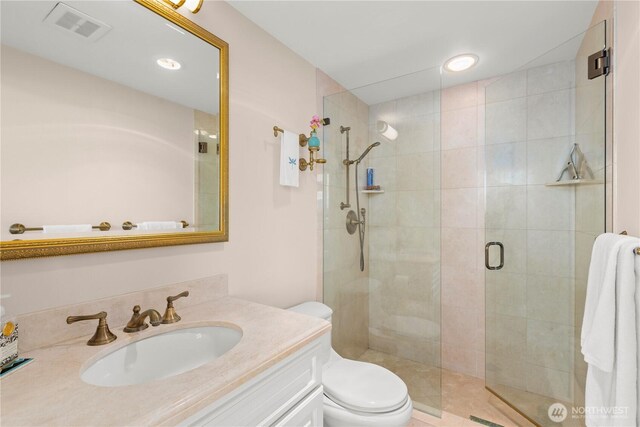 2360 43rd Ave E Unit 415, Seattle, WA 98112 - bathroom with toilet, vanity, a stall shower, and recessed lighting