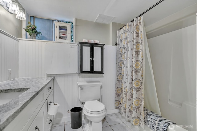 full bathroom featuring tile patterned flooring, curtained shower, toilet, and vanity