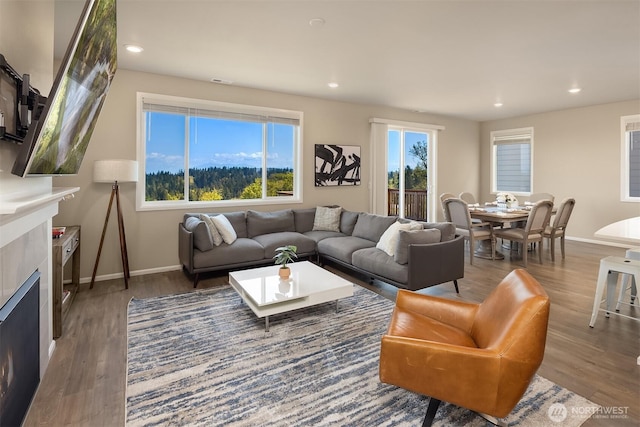 living area with recessed lighting, wood finished floors, and baseboards