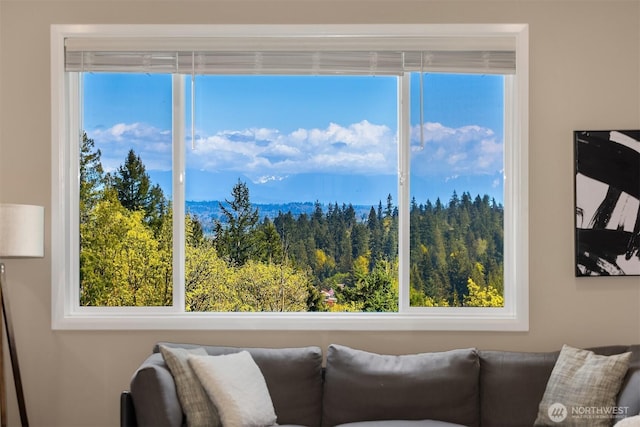 living room with a wooded view