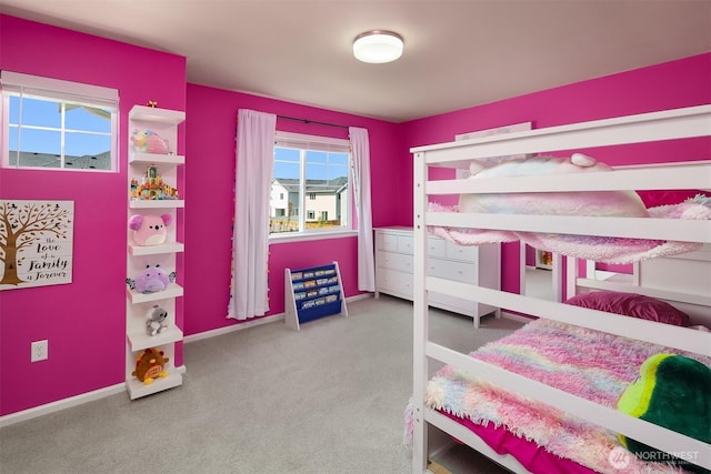 bedroom with baseboards and carpet