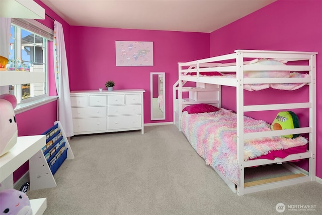 carpeted bedroom featuring baseboards