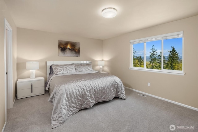 carpeted bedroom featuring visible vents and baseboards