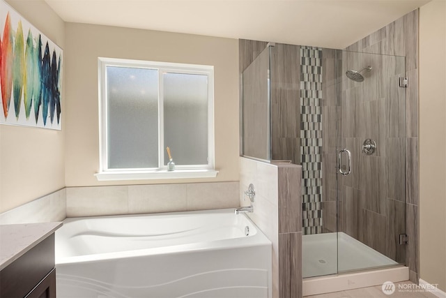 bathroom with a garden tub, vanity, and a shower stall