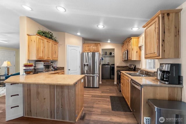 11325 126th St E Unit 229, Puyallup, WA 98374 - kitchen featuring a peninsula, a sink, dark wood-style flooring, light brown cabinets, and appliances with stainless steel finishes