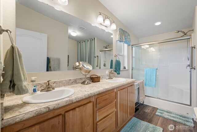11325 126th St E Unit 229, Puyallup, WA 98374 - full bath with double vanity, a shower stall, wood finished floors, and a sink