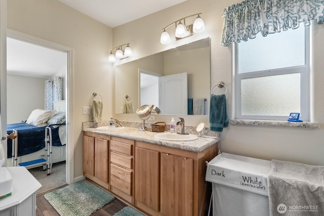 11325 126th St E Unit 229, Puyallup, WA 98374 - full bath with double vanity, wood finished floors, connected bathroom, and a sink
