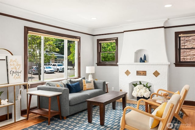living room featuring recessed lighting, ornamental molding, and wood finished floors