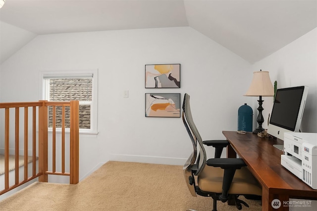 carpeted home office with vaulted ceiling