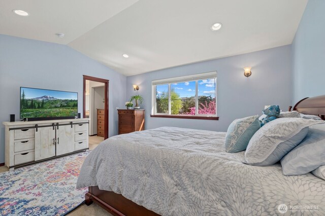bedroom featuring light carpet, vaulted ceiling, and recessed lighting