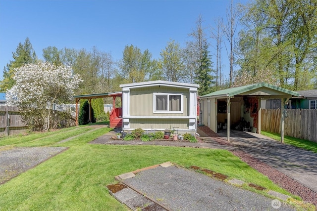 157 Camelot Dr, Castle Rock, WA 98611 - view of front of house featuring a carport, a front yard, and fence