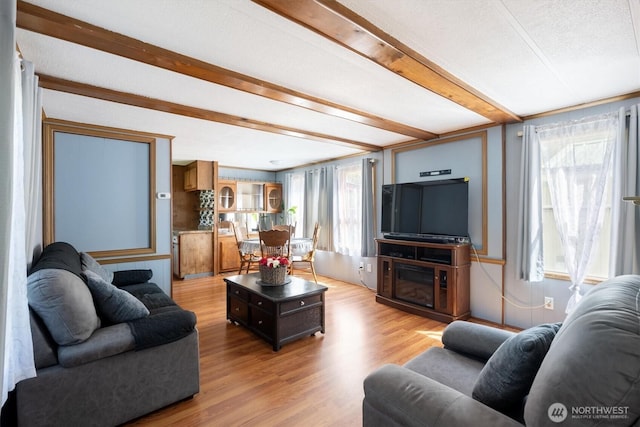 157 Camelot Dr, Castle Rock, WA 98611 - living room with beam ceiling and light wood-style flooring