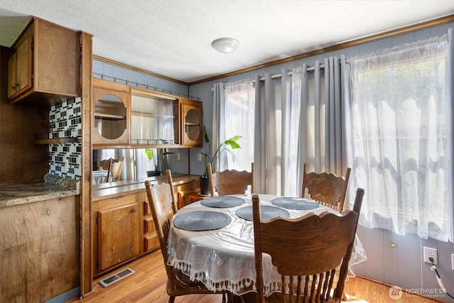 157 Camelot Dr, Castle Rock, WA 98611 - dining area featuring visible vents, crown molding, and light wood-style flooring