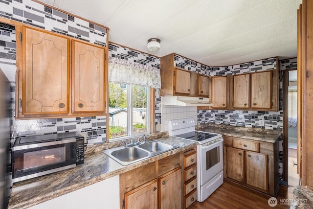 157 Camelot Dr, Castle Rock, WA 98611 - kitchen with white electric range, under cabinet range hood, stainless steel microwave, a sink, and backsplash