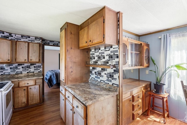 157 Camelot Dr, Castle Rock, WA 98611 - kitchen featuring tasteful backsplash, brown cabinets, white electric range, and wood finished floors