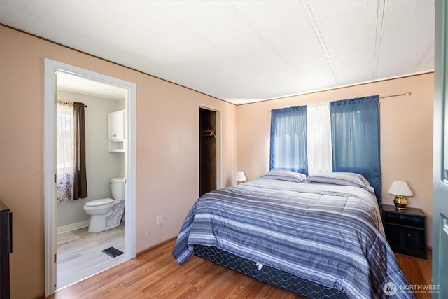 157 Camelot Dr, Castle Rock, WA 98611 - bedroom with a closet, ensuite bathroom, and light wood-type flooring