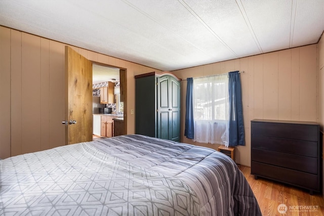 157 Camelot Dr, Castle Rock, WA 98611 - bedroom featuring wood finished floors and wooden walls