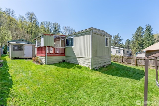 157 Camelot Dr, Castle Rock, WA 98611 - back of property with a yard, a storage shed, an outdoor structure, and fence