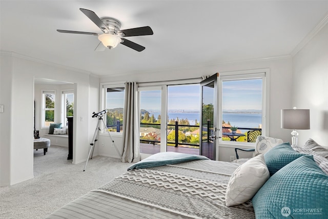 bedroom featuring a water view, ornamental molding, access to exterior, light colored carpet, and baseboards