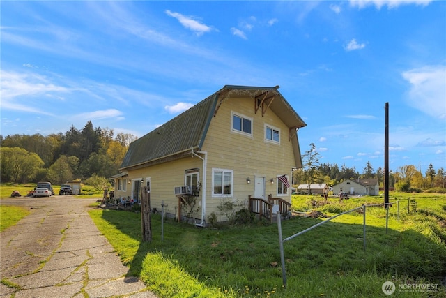 15721 67th Ave NE, Arlington, WA 98223 - view of property exterior with a gambrel roof, driveway, fence, and a lawn