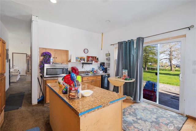 15721 67th Ave NE, Arlington, WA 98223 - kitchen featuring a center island, open shelves, black dishwasher, brown cabinetry, and stainless steel microwave