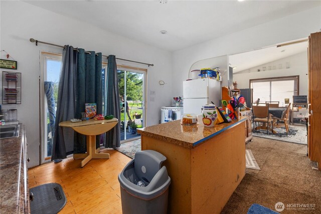 15721 67th Ave NE, Arlington, WA 98223 - kitchen featuring light wood-style floors, freestanding refrigerator, vaulted ceiling, recessed lighting, and a kitchen island
